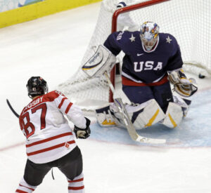 Sidney Crosby (Canada) scores the winning goal vs Ryan Miller (USA)